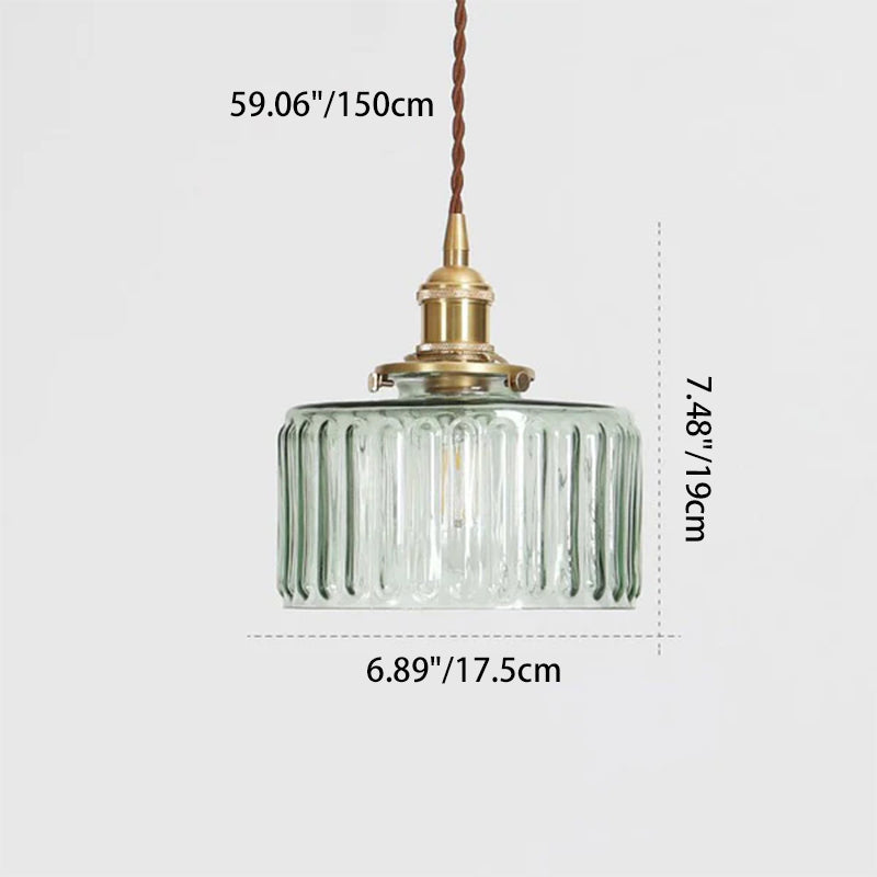 Round pendant light with brass finish and patterned glass shade