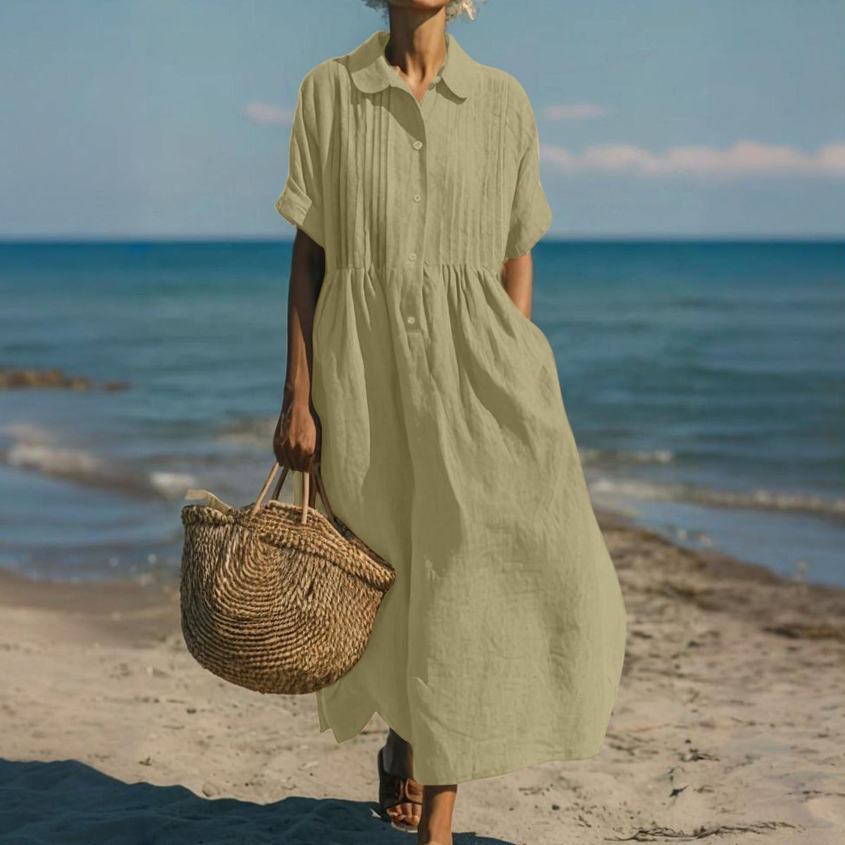 Women's collared button maxi dress with short sleeves and gathered waist at the beach