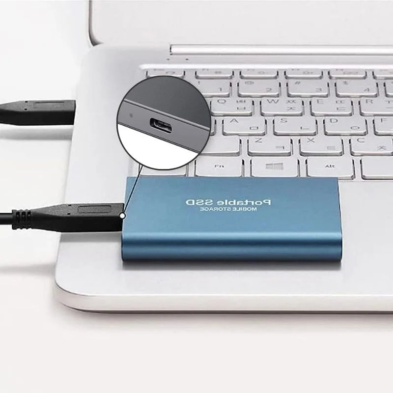Portable SSD connected to a laptop by USB cable