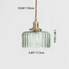 Round pendant light with brass finish and patterned glass shade