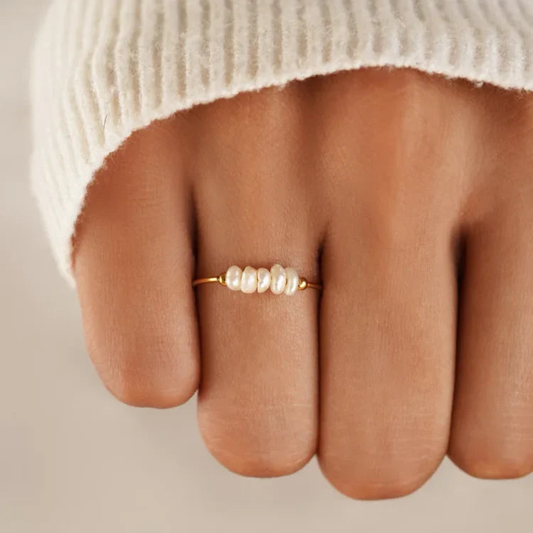 Gold-tone pearl ring with a row of white pearls