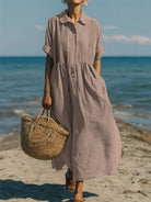 Women's collared button maxi dress with short sleeves and gathered waist at the beach