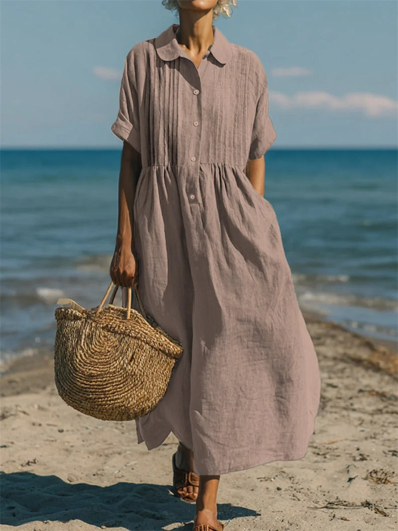 Women's collared button maxi dress with short sleeves and gathered waist at the beach