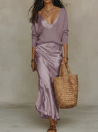 Women's satin midi dress layered with a ribbed knit sweater