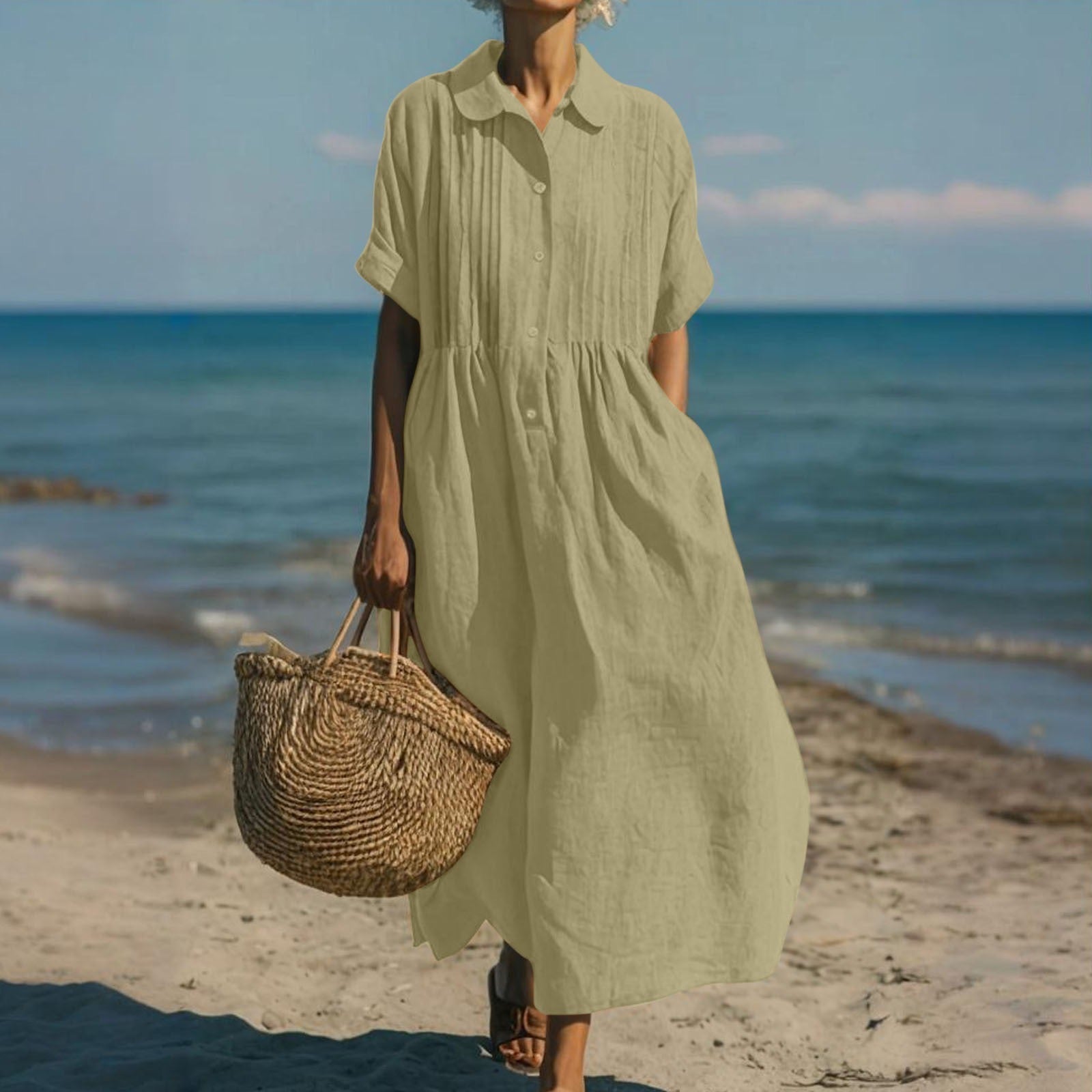 Women's collared button maxi dress with short sleeves and gathered waist at the beach