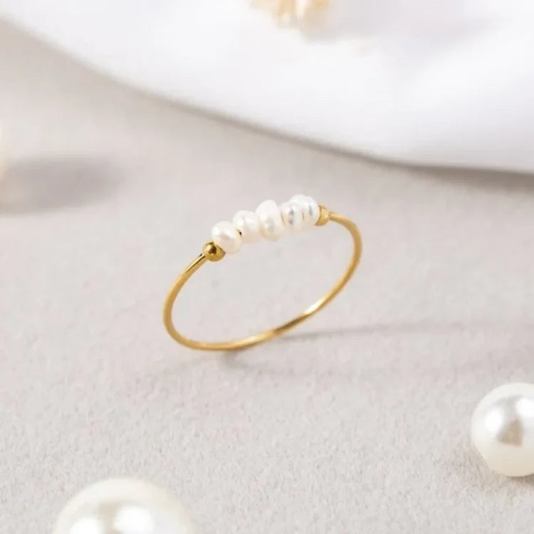 Gold-tone pearl ring with a row of white pearls
