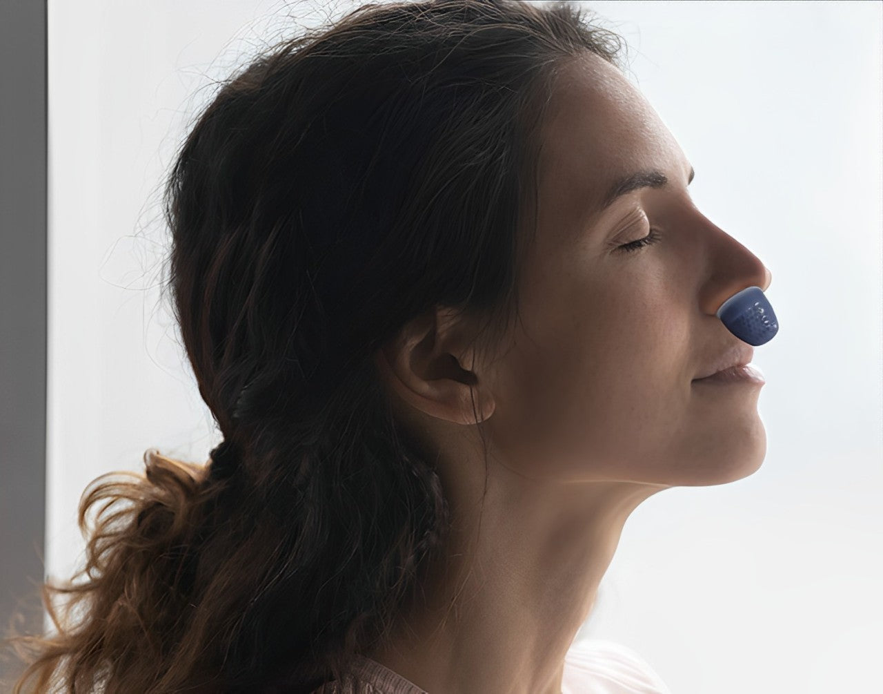 Compact rechargeable anti-snoring device with twin fans and silicone nasal components