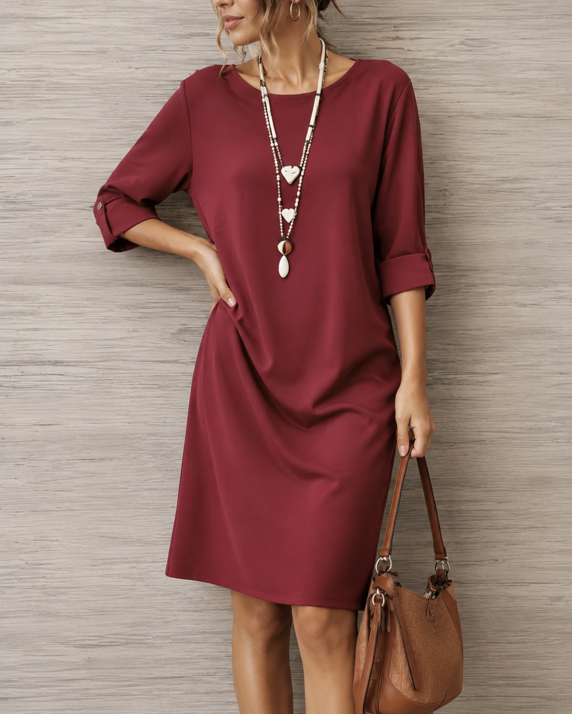 Women's relaxed solid midi dress with round neckline, rolled three-quarter sleeves and side pockets