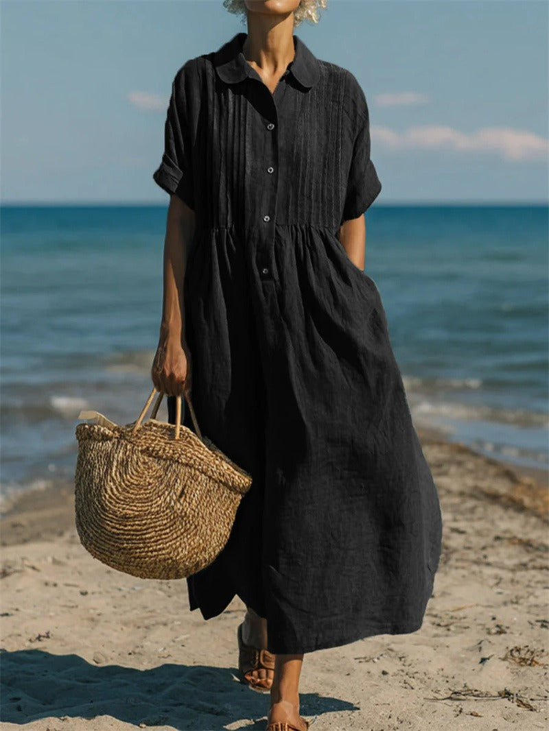 Women's collared button maxi dress with short sleeves and gathered waist at the beach