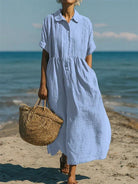 Women's collared button maxi dress with short sleeves and gathered waist at the beach