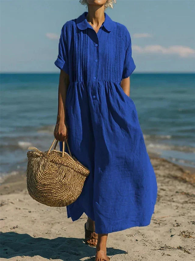 Women's collared button maxi dress with short sleeves and gathered waist at the beach