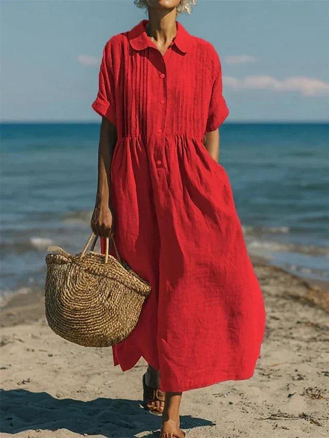 Women's collared button maxi dress with short sleeves and gathered waist at the beach