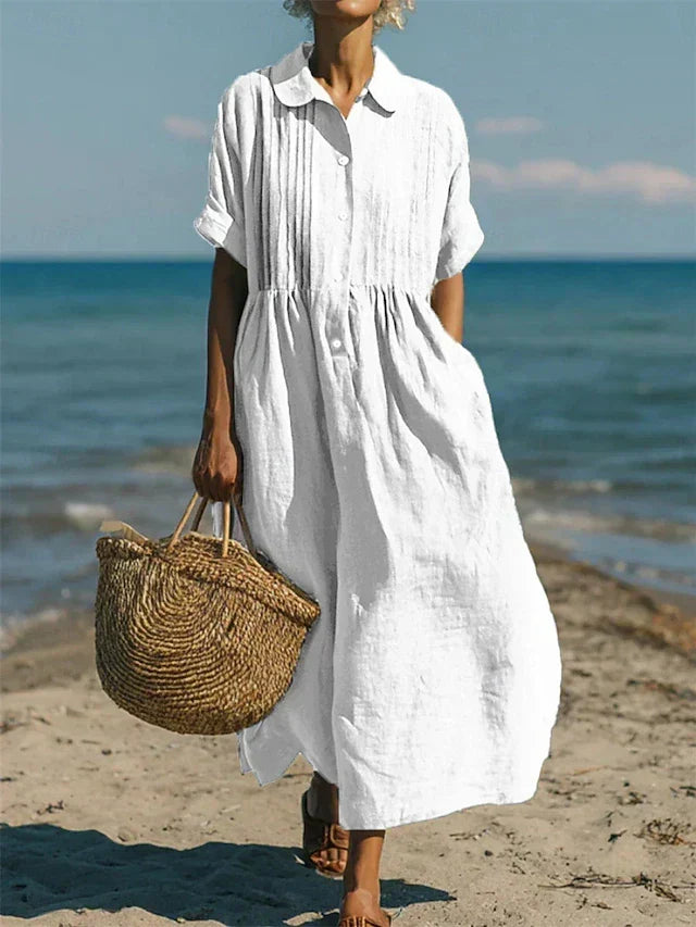 Women's collared button maxi dress with short sleeves and gathered waist at the beach