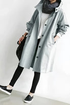 Women's longline hooded trench coat with button front and gathered sleeves