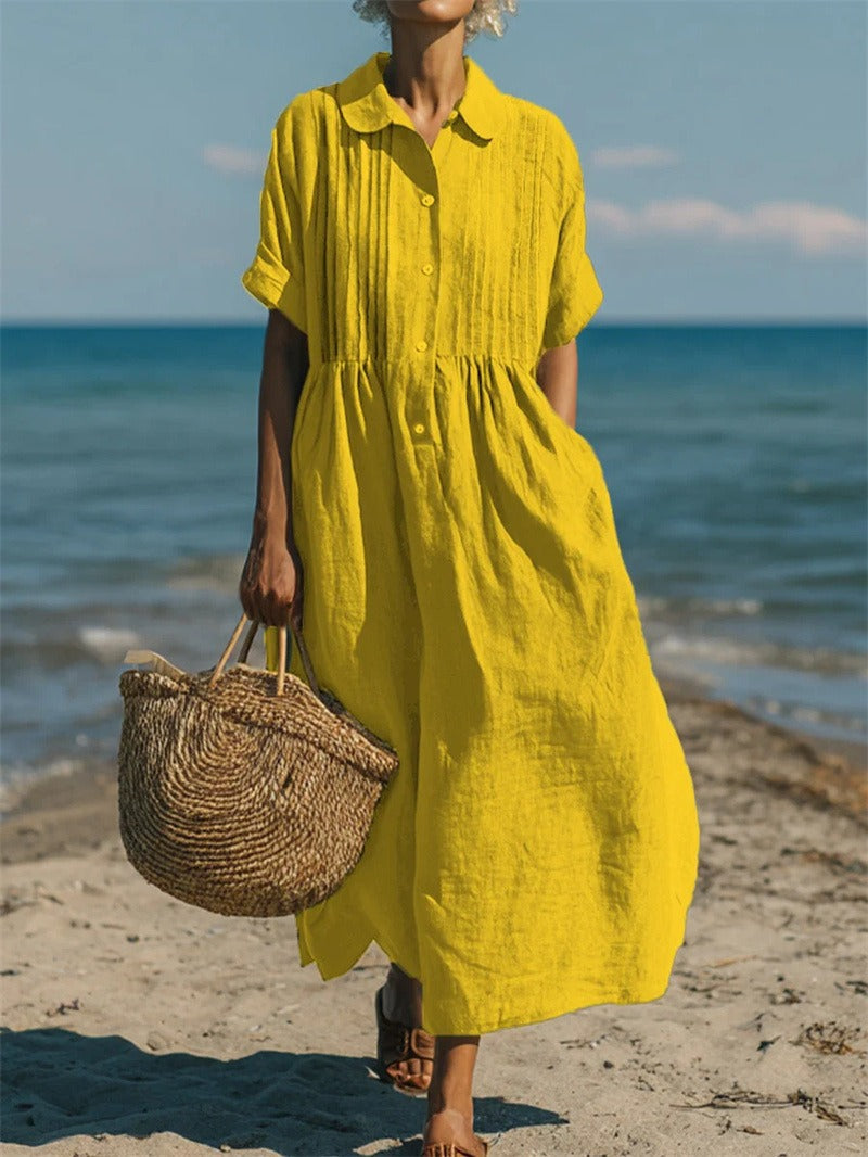 Women's collared button maxi dress with short sleeves and gathered waist at the beach