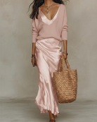 Women's satin midi dress layered with a ribbed knit sweater