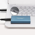 Portable SSD connected to a laptop by USB cable