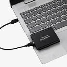 Portable SSD connected to a laptop by USB cable