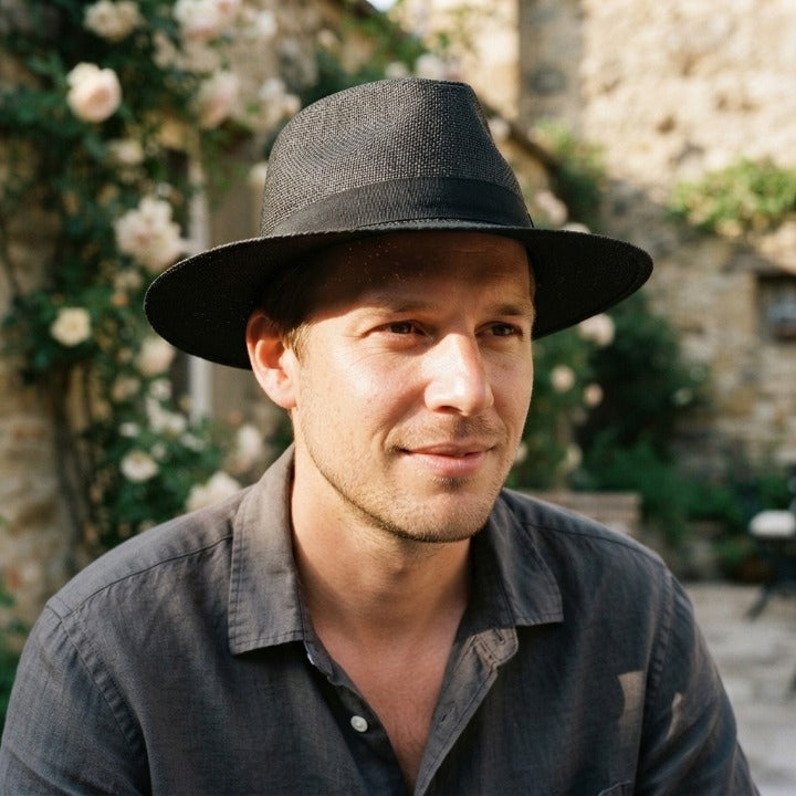 Handwoven straw fedora hat with a wide brim and contrasting band