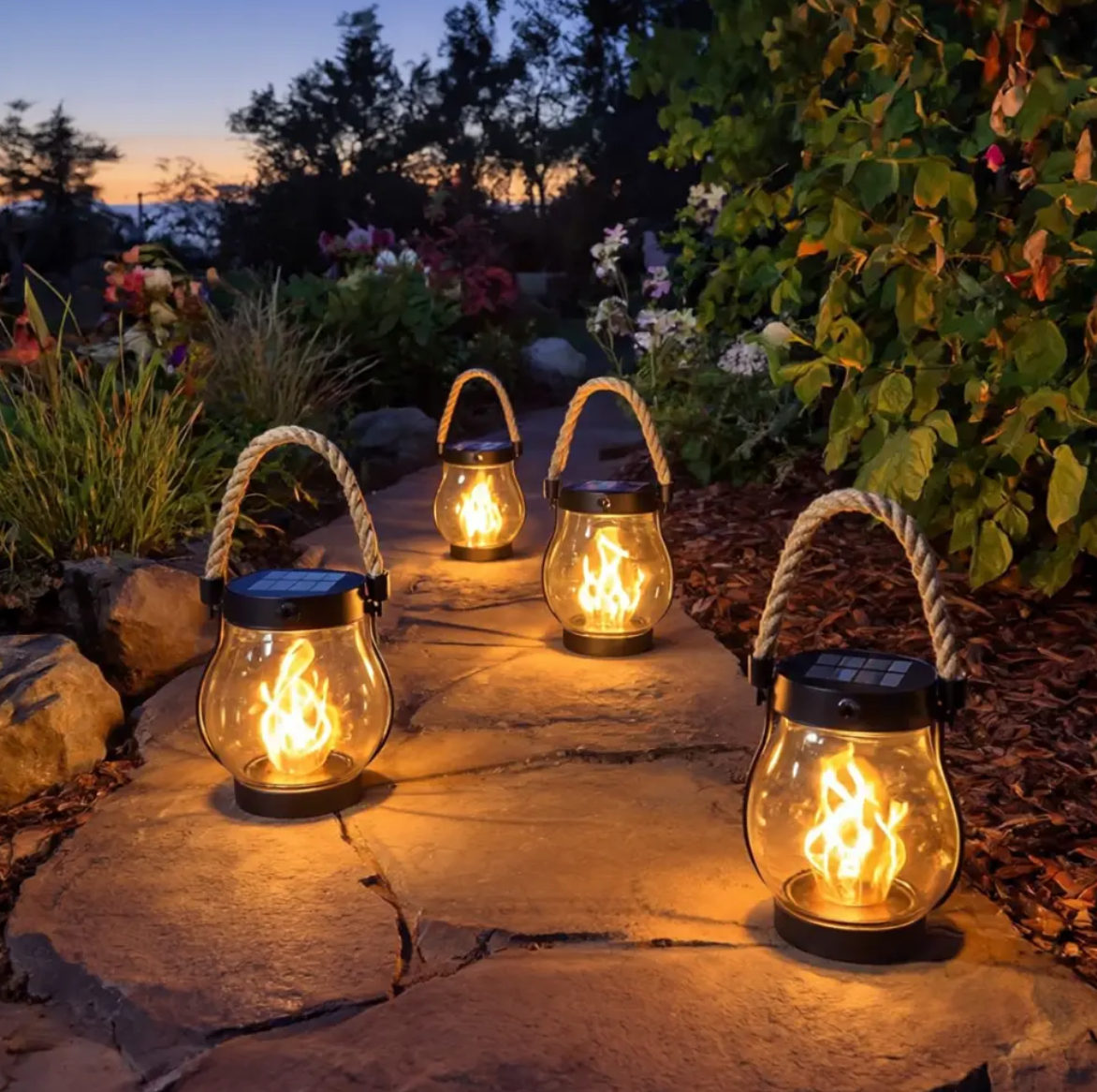 Solar outdoor lantern with flickering flame effect and rope handle