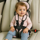 Foldable portable child car seat with integrated harness installed on a vehicle seat