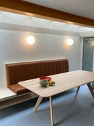 Modern frosted glass globe LED wall sconce mounted on a wall