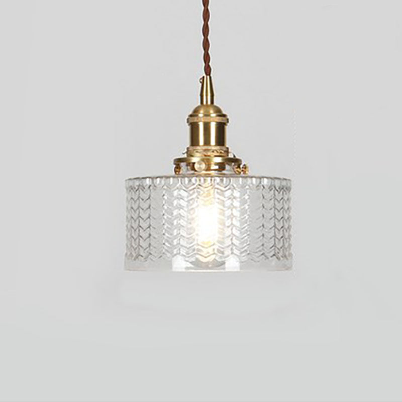 Round pendant light with brass finish and patterned glass shade