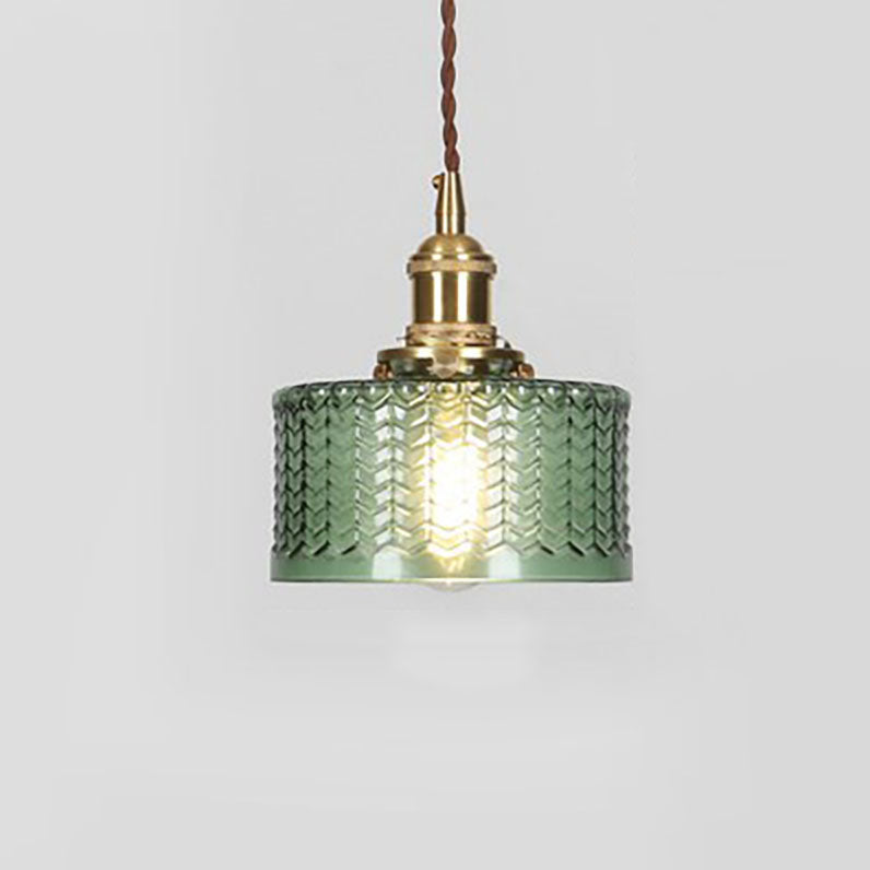 Round pendant light with brass finish and patterned glass shade
