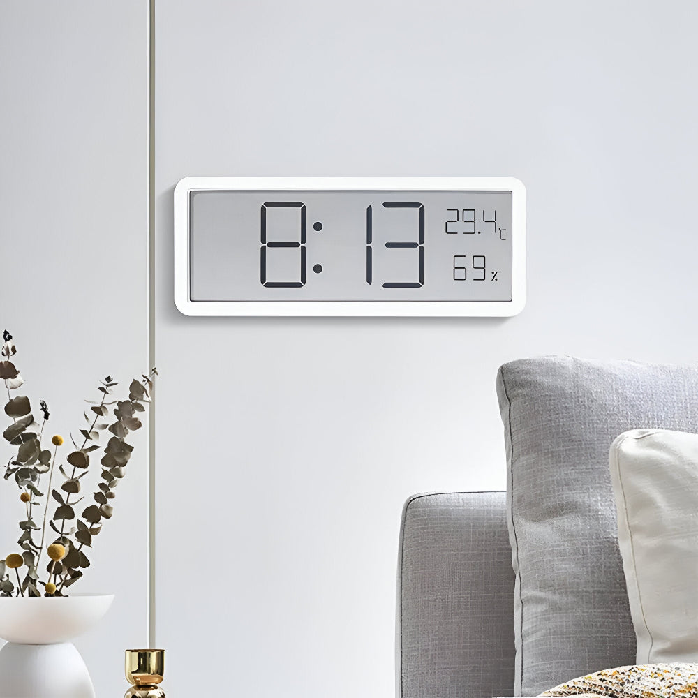 Digital wall clock displaying time, temperature, and humidity
