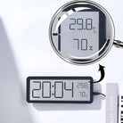 Digital wall clock displaying time, temperature, and humidity