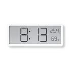 Digital wall clock displaying time, temperature, and humidity