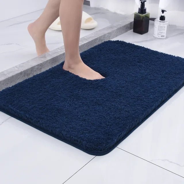 Soft microfiber non-slip bath mat beside a bathtub