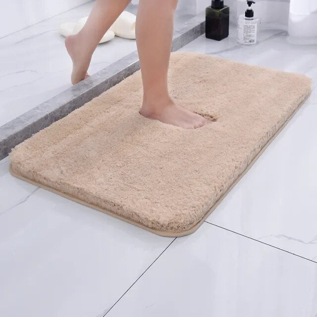 Soft microfiber non-slip bath mat beside a bathtub