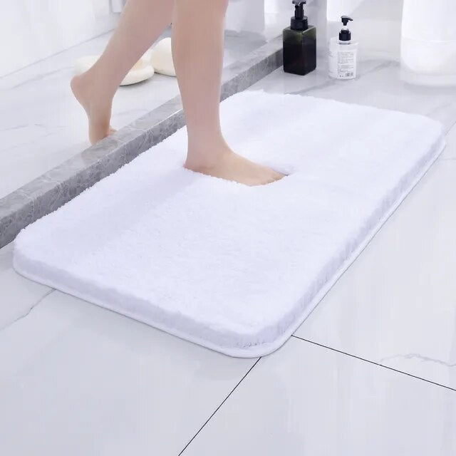 Soft microfiber non-slip bath mat beside a bathtub