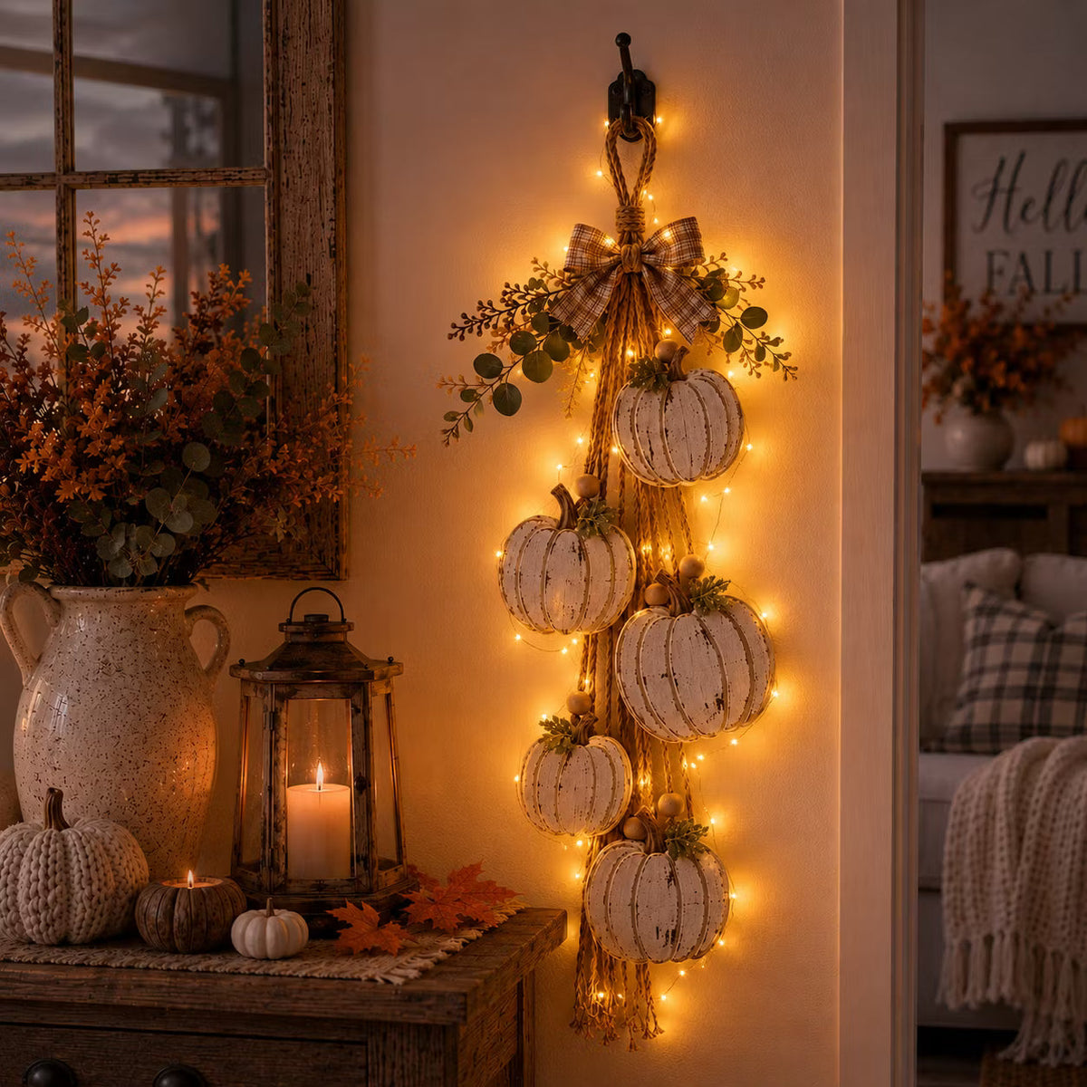 Rustic white pumpkin wall hanging with rope, greenery and plaid bow