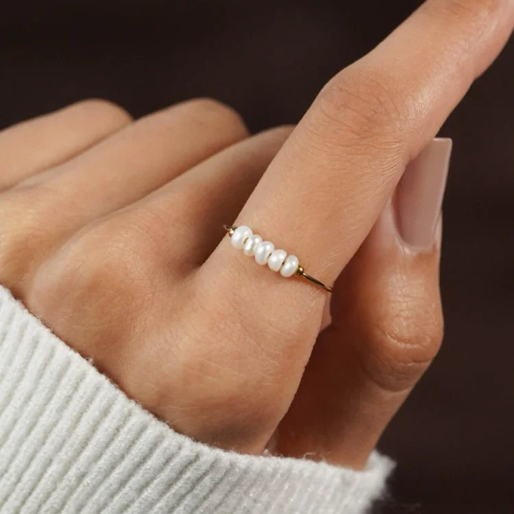 Gold-tone pearl ring with a row of white pearls
