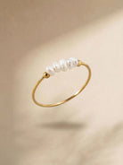Gold-tone pearl ring with a row of white pearls