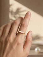 Gold-tone pearl ring with a row of white pearls