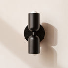 Modern two-light LED cylinder wall sconce with round backplate
