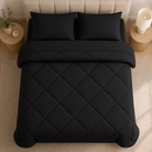 Quilted comforter with geometric diamond stitching on a bed
