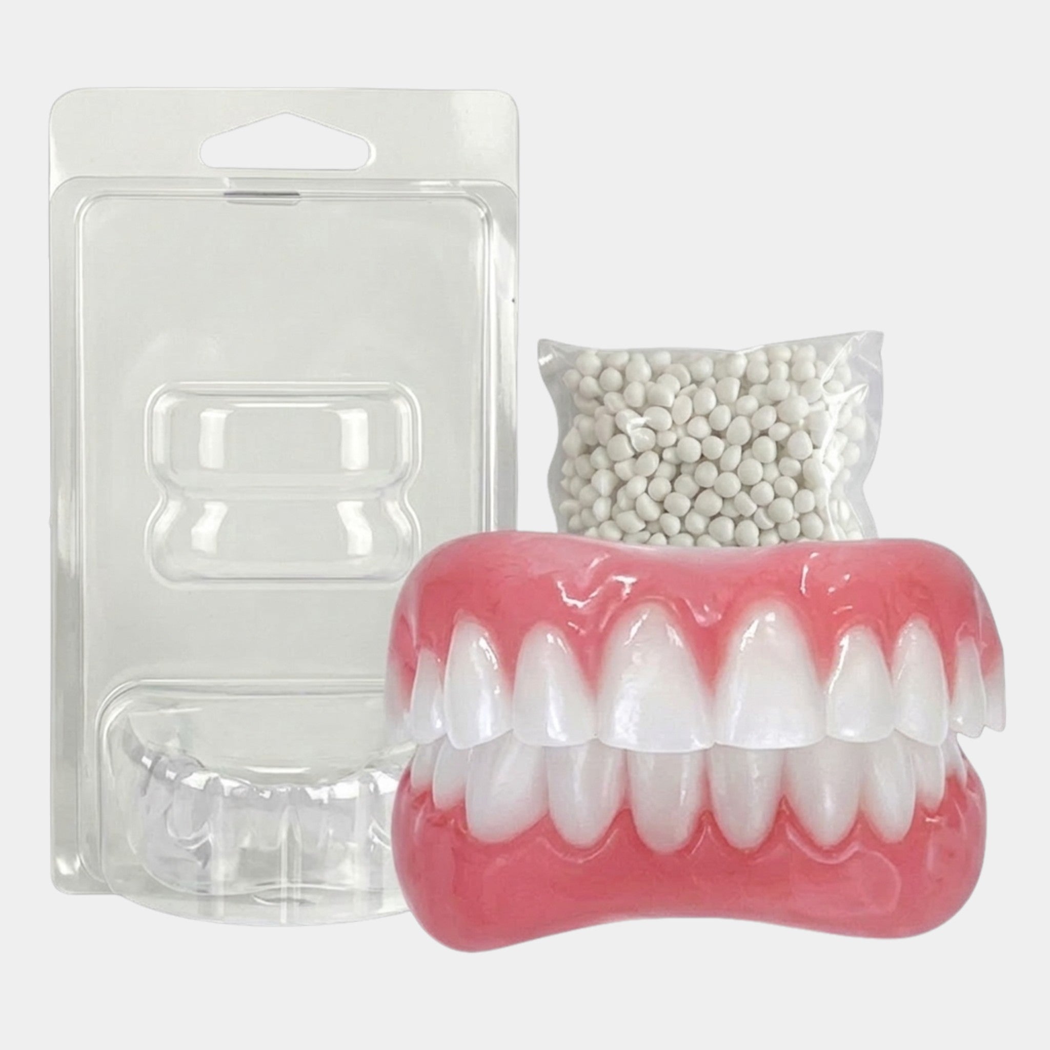 Removable upper and lower dental prosthesis set with pink gum sections and white teeth
